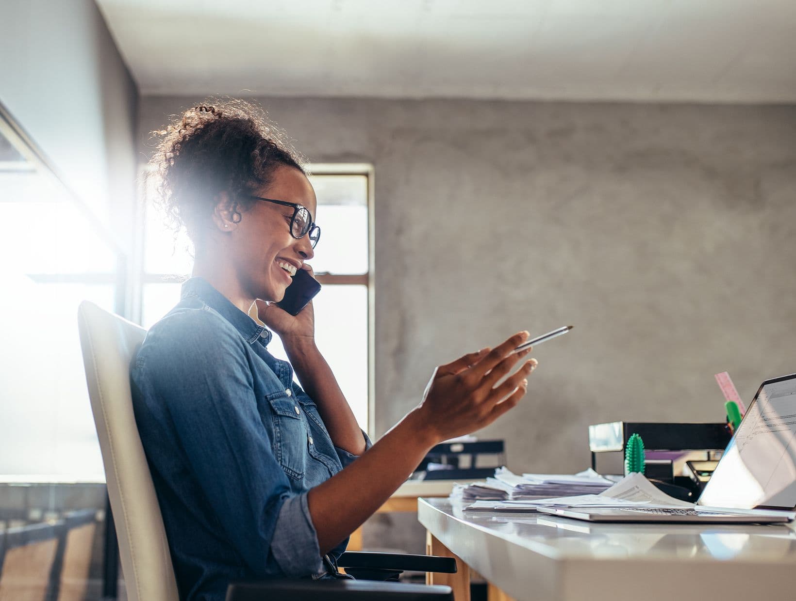 woman on phone at desk